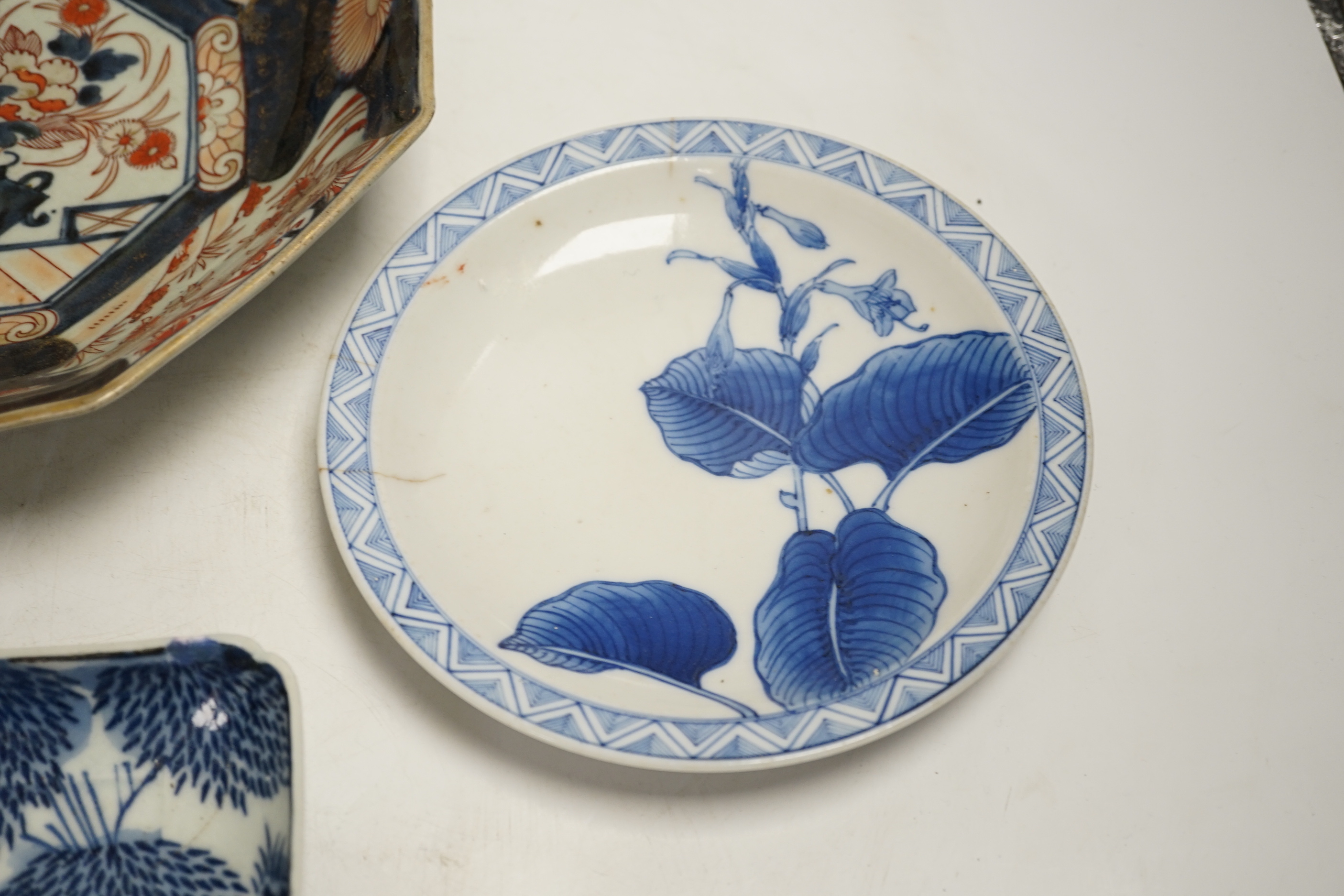 A late 17th/early 18th century Japanese Arita dish (a.f) and two other Arita pieces, largest 27cm